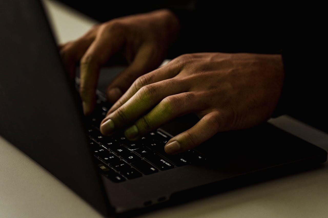Crop unrecognizable person typing on laptop keyboard